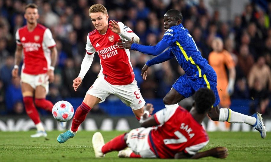 Martin Odegaard (L) of Arsenal in action against N'Golo Kante (R) of Chelsea during the English Premier League soccer match between Chelsea FC and Arsenal FC in London