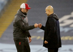 Manchester City manager Pep Guardiola and Liverpool manager Jurgen Klopp bump fists after the match at the Etihad Stadium in Manchester on November 8, 2020